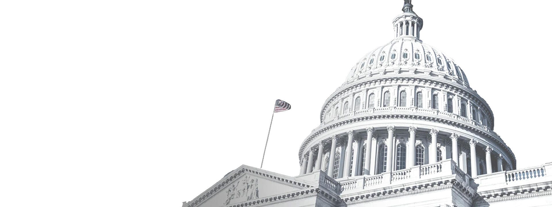 a large white building with columns and a flag on top with United States Capitol in the background