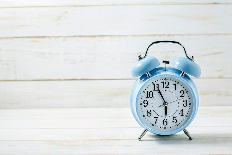a clock with a kettle on top