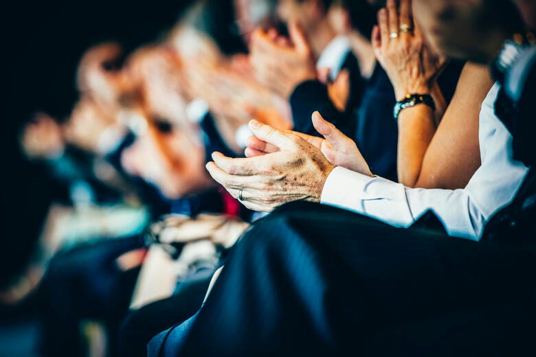 a group of people clapping