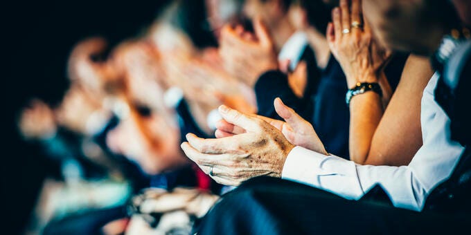 a group of people clapping