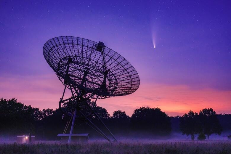 a large satellite dish in a field