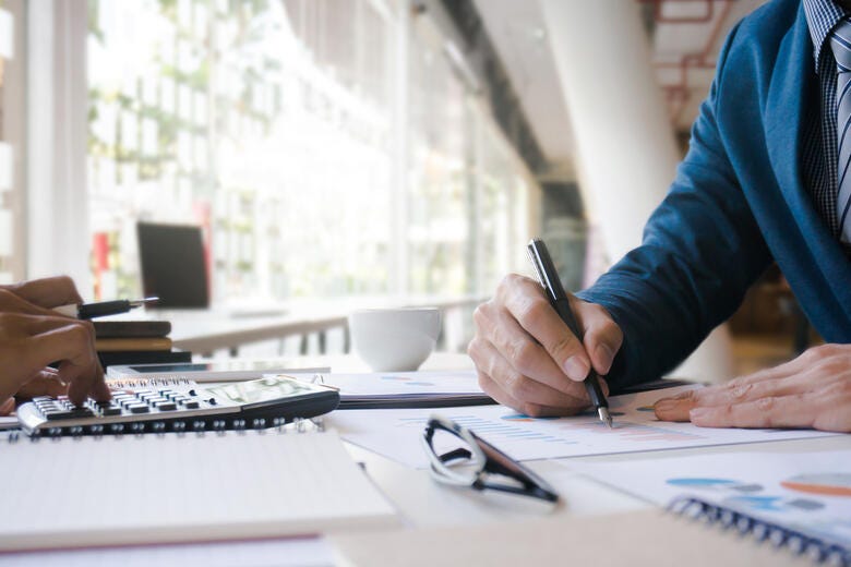 a person writing on a piece of paper