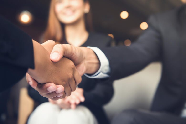 a close-up of people shaking hands