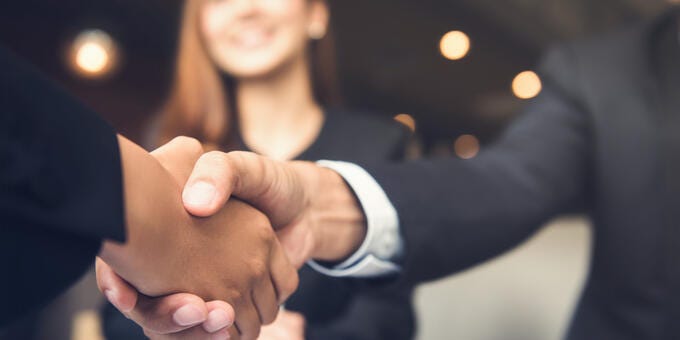a close-up of people shaking hands