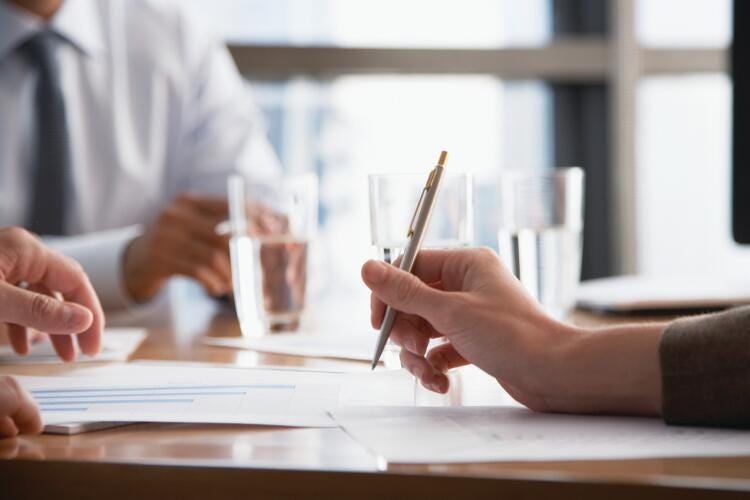 a person writing on a piece of paper
