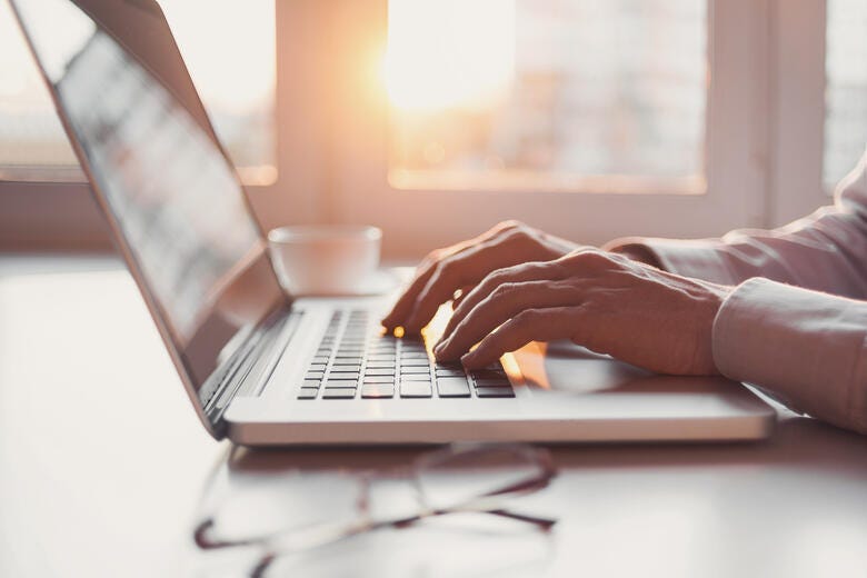 a person typing on a laptop