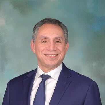 a man in a suit smiling
