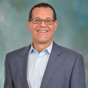 a man wearing glasses and a suit