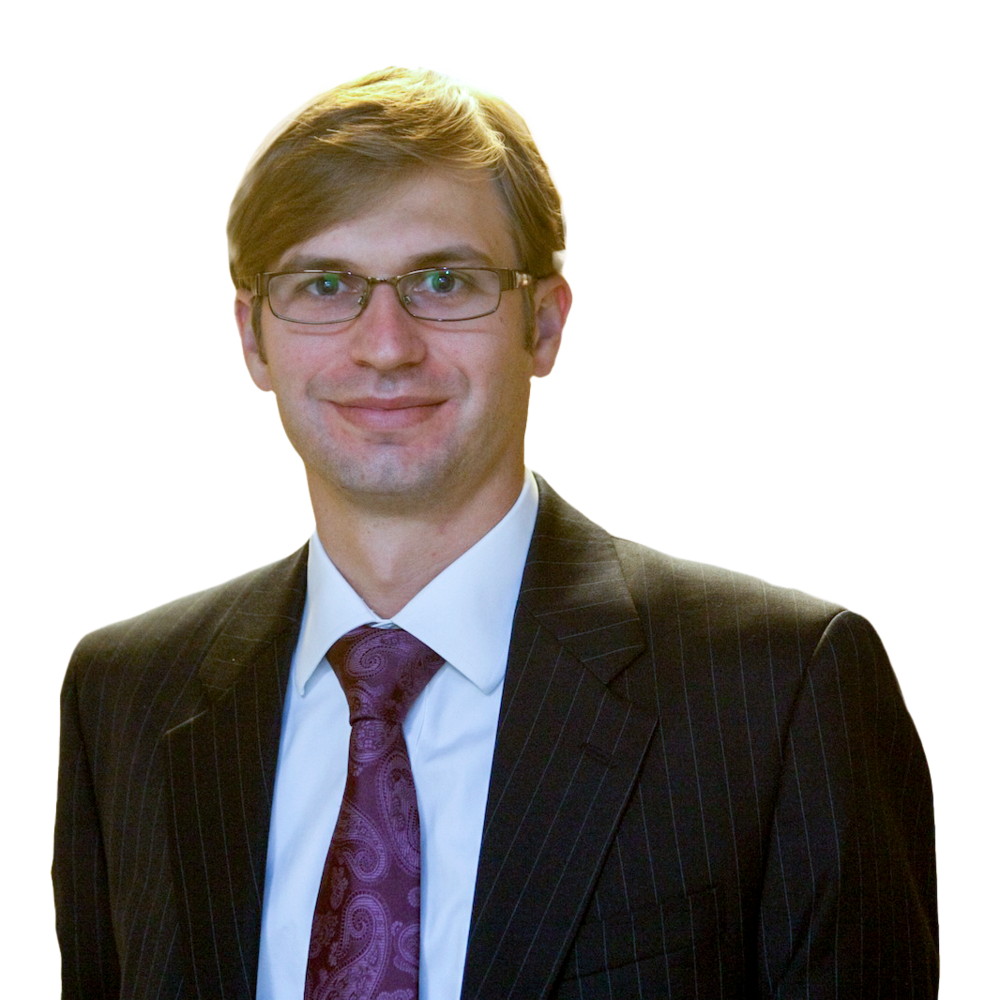 László Böröcz wearing glasses and a suit